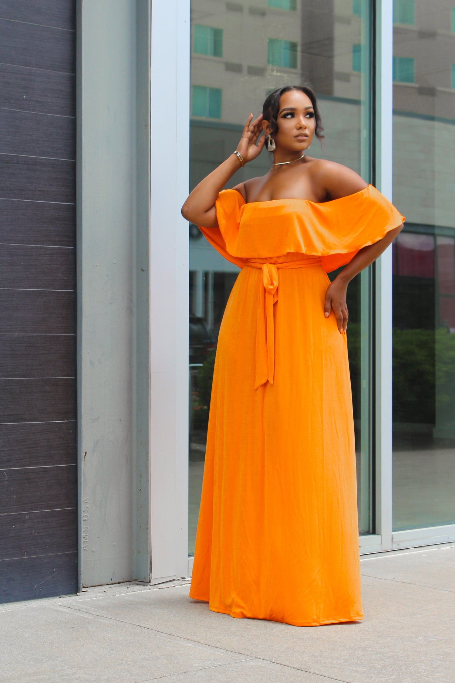 woman posing in a orange dress