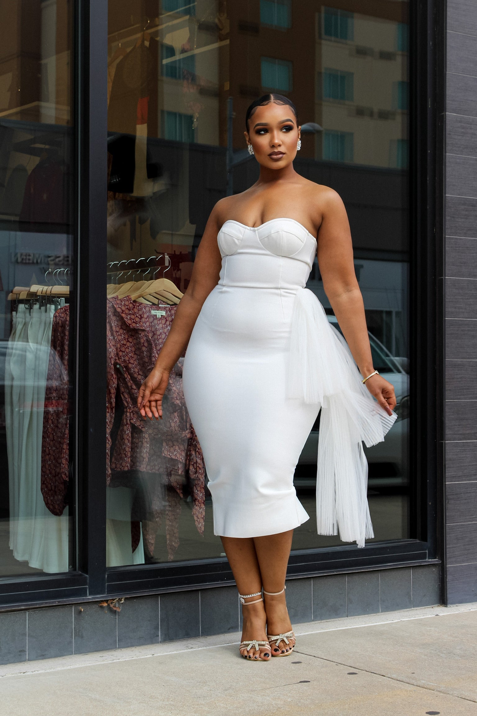 Woman wearing white dress and posing elegantly