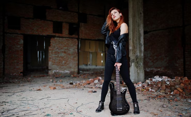 woman posing for a picture while holding guitar