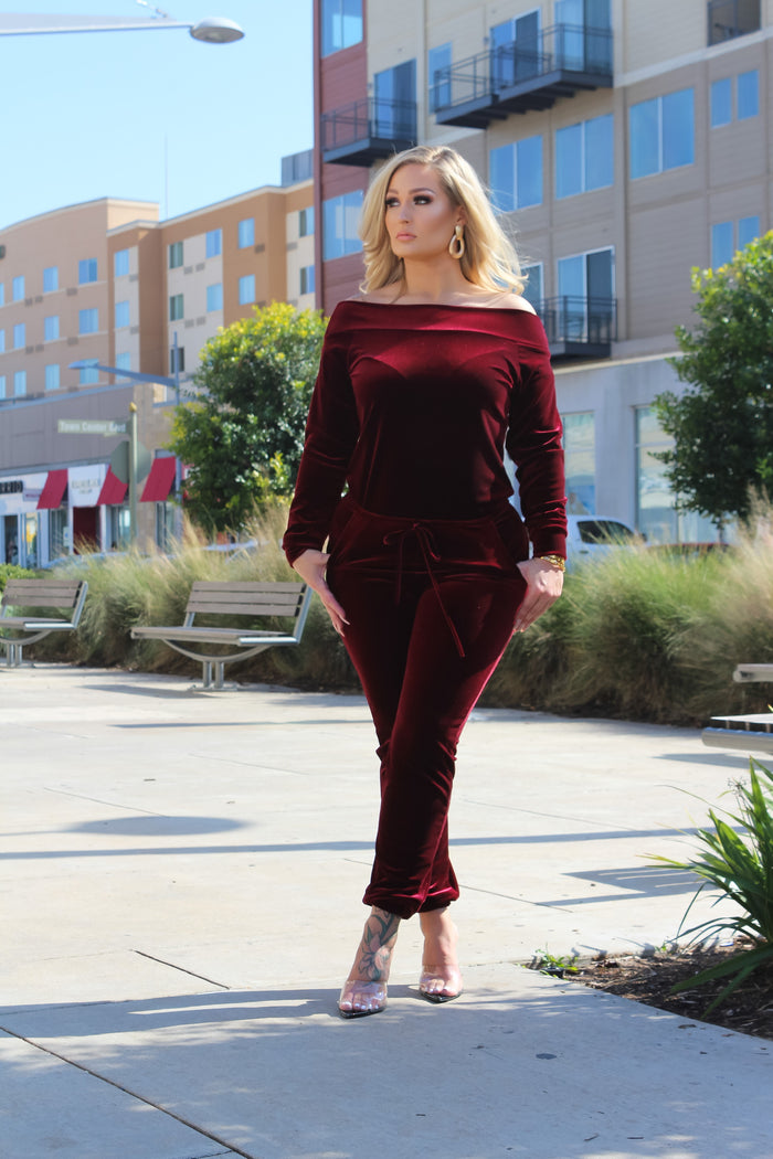 woman wearing red off shoulder jumpsuit